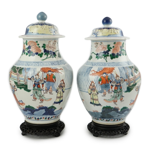 168 - A pair of large Chinese wucai jars and covers, late 19th century, each finely painted with dignitari... 