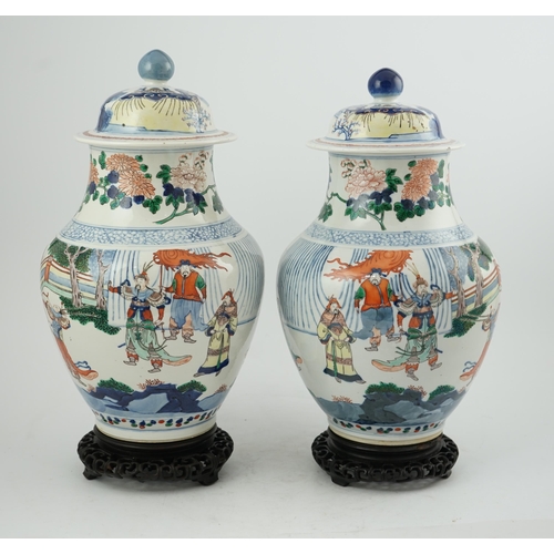 168 - A pair of large Chinese wucai jars and covers, late 19th century, each finely painted with dignitari... 