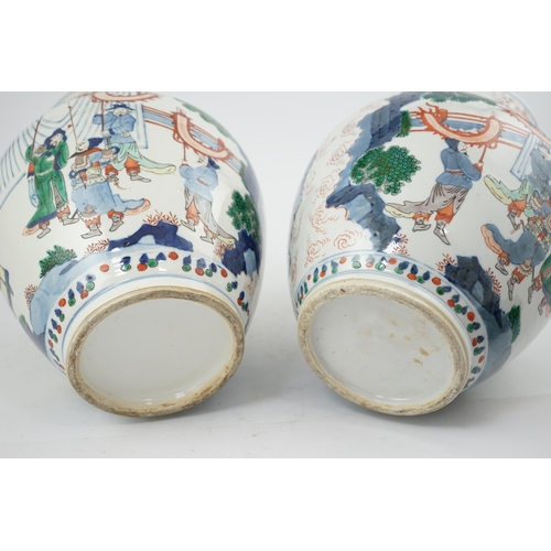 168 - A pair of large Chinese wucai jars and covers, late 19th century, each finely painted with dignitari... 