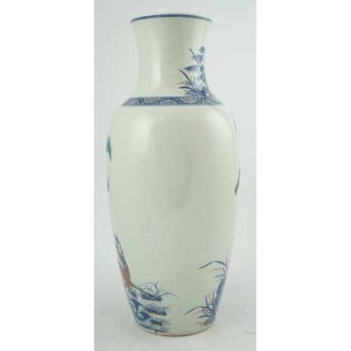 169 - An unusual Chinese underglaze blue and copper red longevity vase, 19th century, of elongated ovoid... 