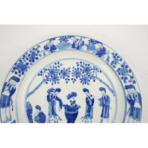 177 - A Chinese blue and white 'ladies' plate, Kangxi mark, 19th century, painted with four ladies in a ga... 