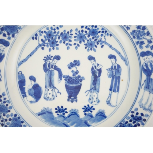 177 - A Chinese blue and white 'ladies' plate, Kangxi mark, 19th century, painted with four ladies in a ga... 