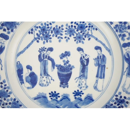 177 - A Chinese blue and white 'ladies' plate, Kangxi mark, 19th century, painted with four ladies in a ga... 