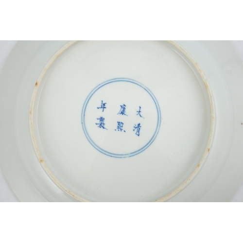 177 - A Chinese blue and white 'ladies' plate, Kangxi mark, 19th century, painted with four ladies in a ga... 