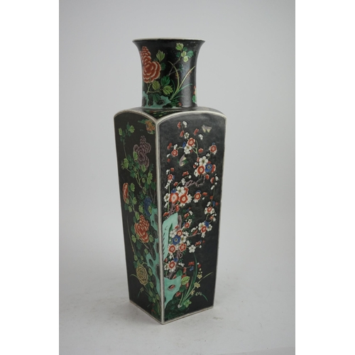 179 - A large Chinese famille noire square baluster vase, 19th century in Kangxi style, painted to each si... 