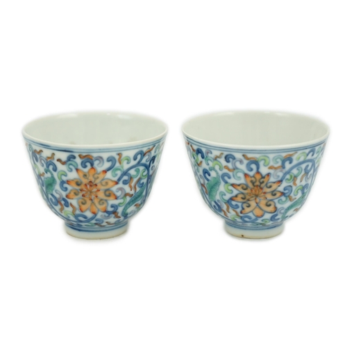 183 - A pair of Chinese doucai cups, Guangxu mark and period (1875-1908), each painted with lotus flowers,... 