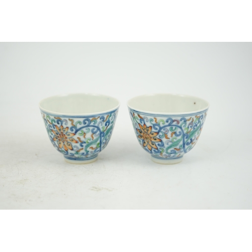 183 - A pair of Chinese doucai cups, Guangxu mark and period (1875-1908), each painted with lotus flowers,... 