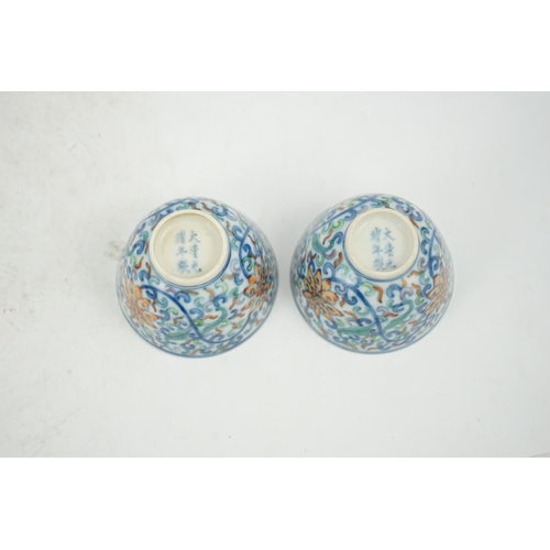 183 - A pair of Chinese doucai cups, Guangxu mark and period (1875-1908), each painted with lotus flowers,... 