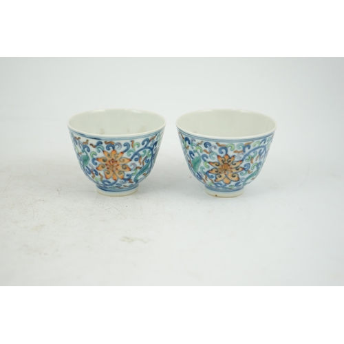 183 - A pair of Chinese doucai cups, Guangxu mark and period (1875-1908), each painted with lotus flowers,... 