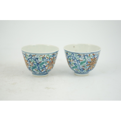 183 - A pair of Chinese doucai cups, Guangxu mark and period (1875-1908), each painted with lotus flowers,... 