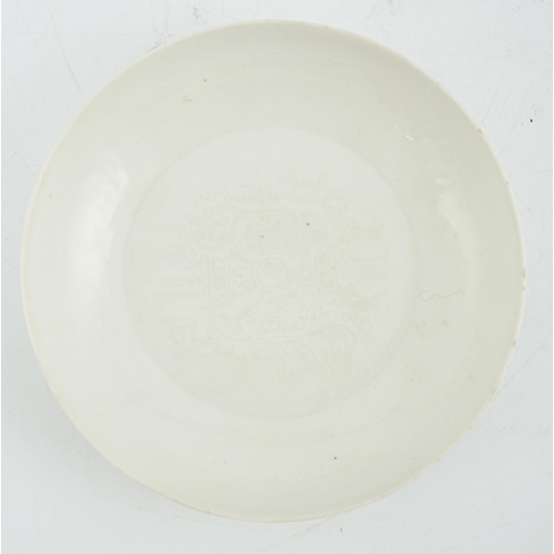 191 - A Chinese moulded white glazed saucer dish, Yongle mark, Republic period, the centre moulded with a ... 