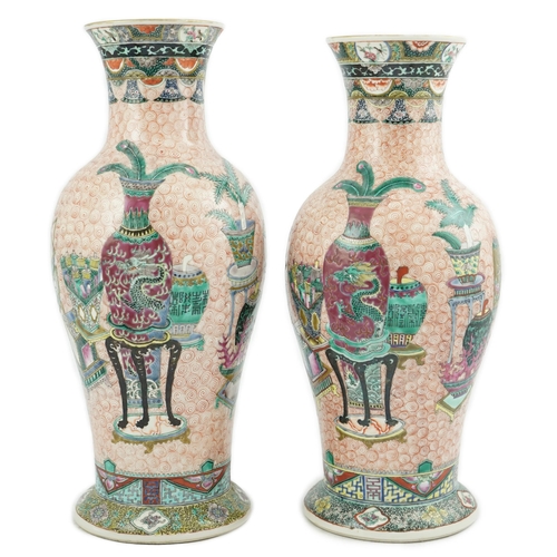 193 - A near pair of Chinese famille rose Hundred Antiques baluster vases, Kangxi mark, early 20th centu... 