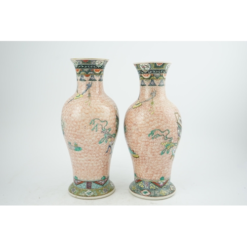 193 - A near pair of Chinese famille rose Hundred Antiques baluster vases, Kangxi mark, early 20th centu... 