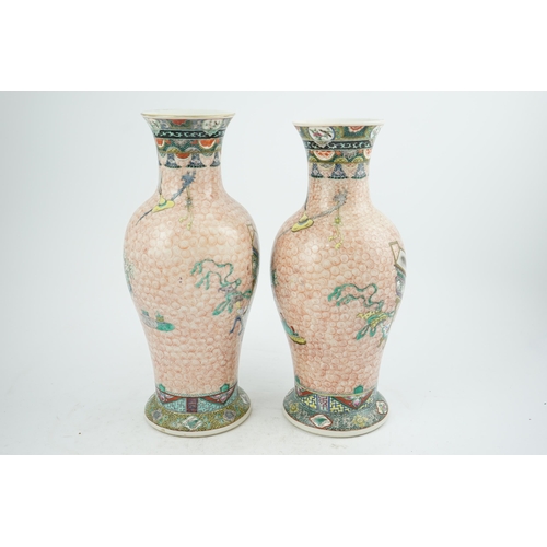 193 - A near pair of Chinese famille rose Hundred Antiques baluster vases, Kangxi mark, early 20th centu... 