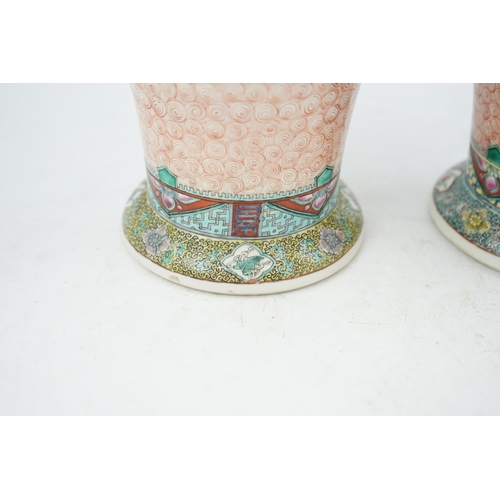 193 - A near pair of Chinese famille rose Hundred Antiques baluster vases, Kangxi mark, early 20th centu... 