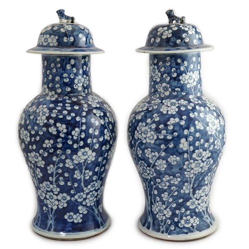 194 - A pair of large Chinese blue and white prunus baluster vases and covers, 19th century, each cylind... 