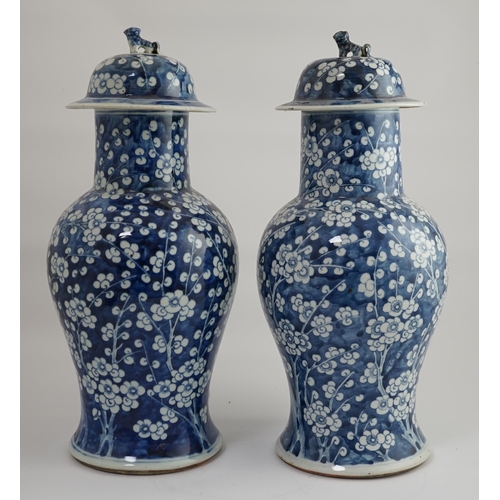 194 - A pair of large Chinese blue and white prunus baluster vases and covers, 19th century, each cylind... 