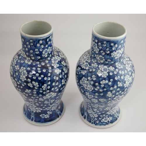 194 - A pair of large Chinese blue and white prunus baluster vases and covers, 19th century, each cylind... 