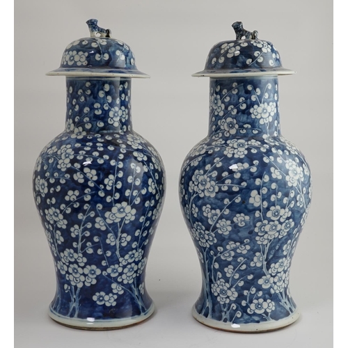 194 - A pair of large Chinese blue and white prunus baluster vases and covers, 19th century, each cylind... 