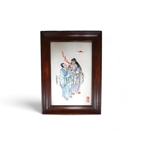 196 - A Chinese famille rose plaque of the immortals Lu Dongbin and Zhang Guo, Republic period, the figure... 