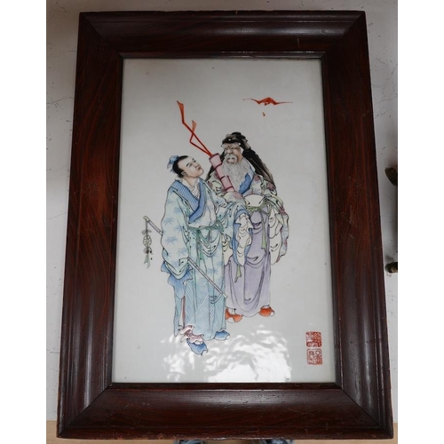 196 - A Chinese famille rose plaque of the immortals Lu Dongbin and Zhang Guo, Republic period, the figure... 