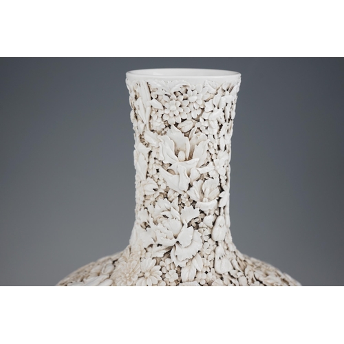 201 - A large Chinese carved porcelain thousand flower bottle vase, 20th century, intricately carved and... 