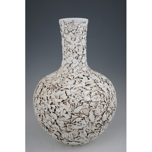 201 - A large Chinese carved porcelain thousand flower bottle vase, 20th century, intricately carved and... 