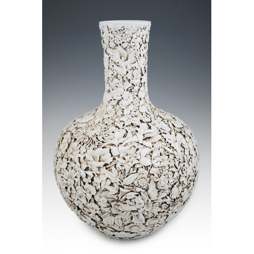 201 - A large Chinese carved porcelain thousand flower bottle vase, 20th century, intricately carved and... 