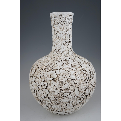 201 - A large Chinese carved porcelain thousand flower bottle vase, 20th century, intricately carved and... 