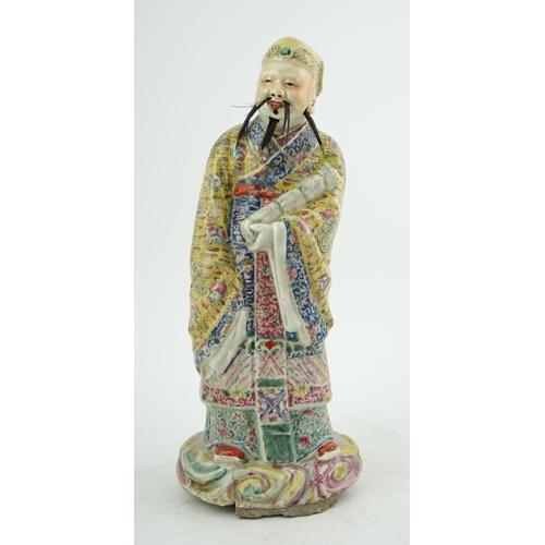 206 - A Chinese famille rose figure of Fuxing, early 20th century, standing and holding a scroll, wearing ... 