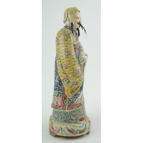 206 - A Chinese famille rose figure of Fuxing, early 20th century, standing and holding a scroll, wearing ... 