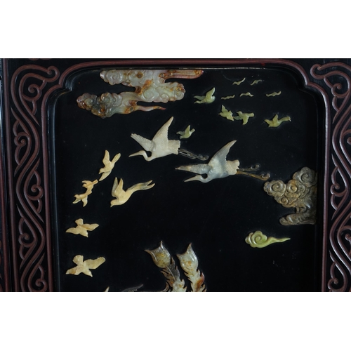 210 - A Chinese tixi lacquer and carved soapstone overlaid six panel screen, mid 20th century, relief deco... 