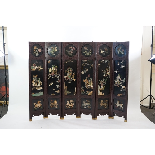 210 - A Chinese tixi lacquer and carved soapstone overlaid six panel screen, mid 20th century, relief deco... 