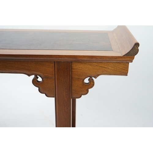 212 - A Chinese padouk wood and jichimu altar table, the panelled rectangular top with scroll ends, on pla... 