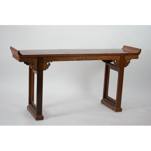 212 - A Chinese padouk wood and jichimu altar table, the panelled rectangular top with scroll ends, on pla... 