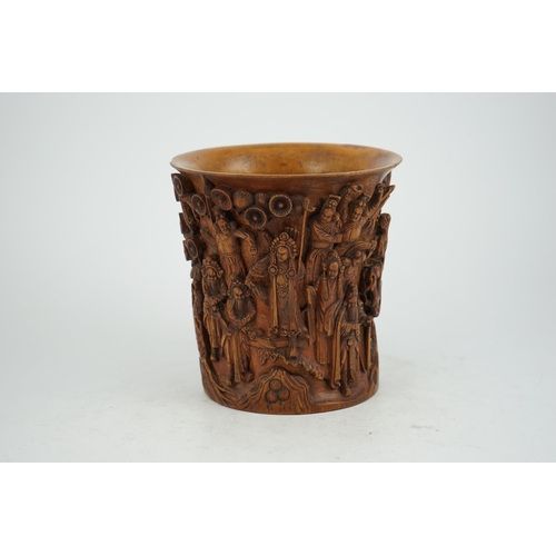 220 - A Chinese bamboo brush pot, 19th century, carved in high relief with a procession of dignitaries in ... 