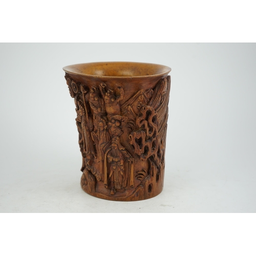 220 - A Chinese bamboo brush pot, 19th century, carved in high relief with a procession of dignitaries in ... 