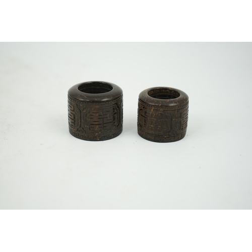 221 - A pair of rare Chinese Straits palm wood archer's thumb rings, 19th century, each carved in relief w... 