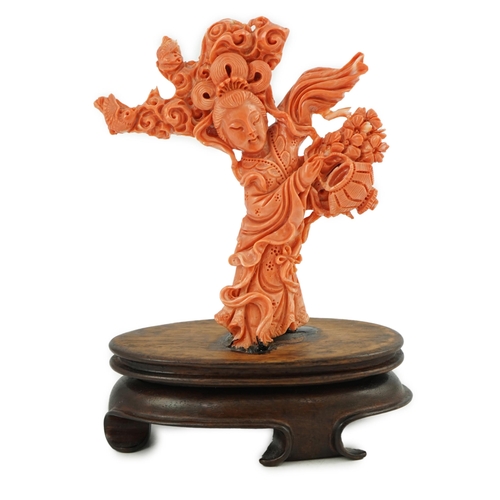 224 - A large Chinese coral carving of a flower fairy, mid 20th century, 14cm high, glued to wood stand... 