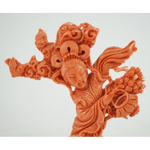 224 - A large Chinese coral carving of a flower fairy, mid 20th century, 14cm high, glued to wood stand... 