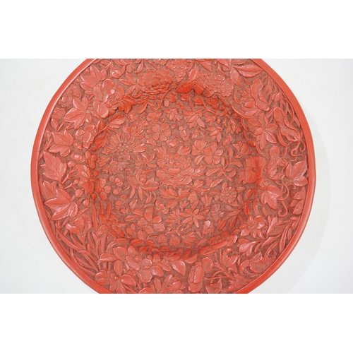 227 - An unusual Chinese cinnabar lacquer thousand flower footed dish, 18th/19th century, finely carved ... 