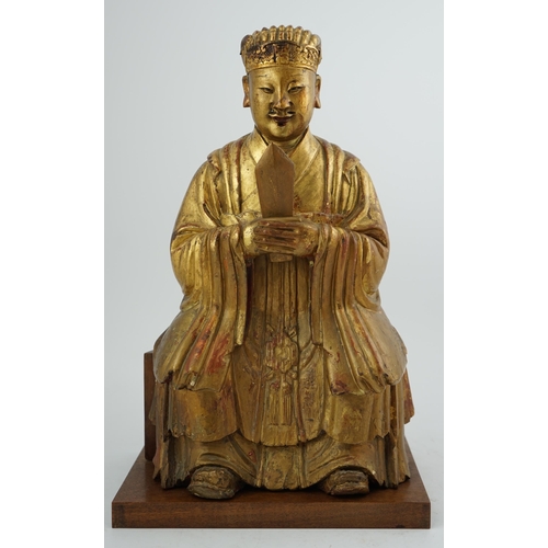 230 - A Chinese gilt lacquered wood seated figure of Wenchang Wang, late Ming, 17th century, the figure ho... 