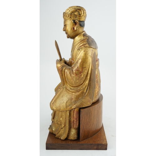 230 - A Chinese gilt lacquered wood seated figure of Wenchang Wang, late Ming, 17th century, the figure ho... 