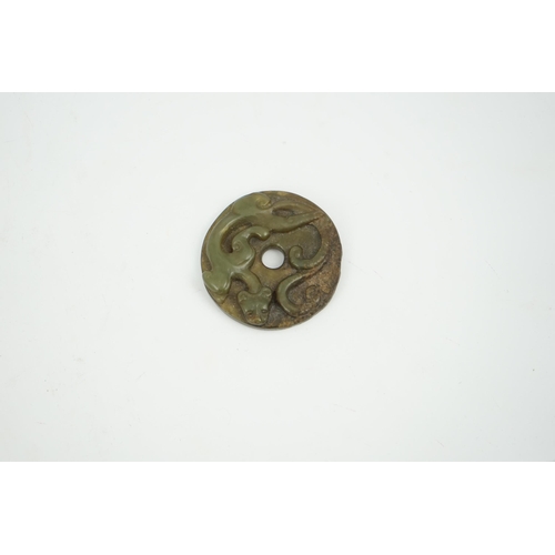 233 - A Chinese green and brown jade bi disc, Yuan/Ming dynasty, 4.3cm diameter