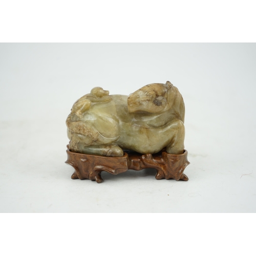 234 - A Chinese celadon and mottled brown jade figure of a monkey climbing on a recumbent horse, Ming dyna... 