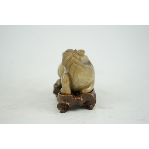 234 - A Chinese celadon and mottled brown jade figure of a monkey climbing on a recumbent horse, Ming dyna... 