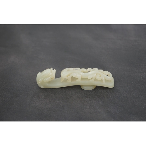 235 - A Chinese white jade dragon belt hook, 18th/19th century, the stone of excellent even tone, carved... 