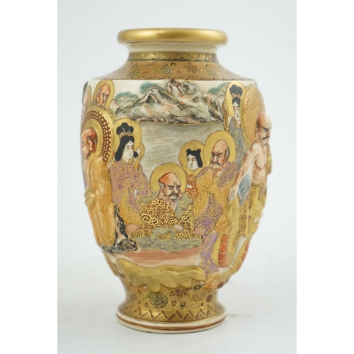 25 - A Japanese Satsuma relief moulded rakan vase, Meiji period, painted with Kwannon, rakan and other ... 