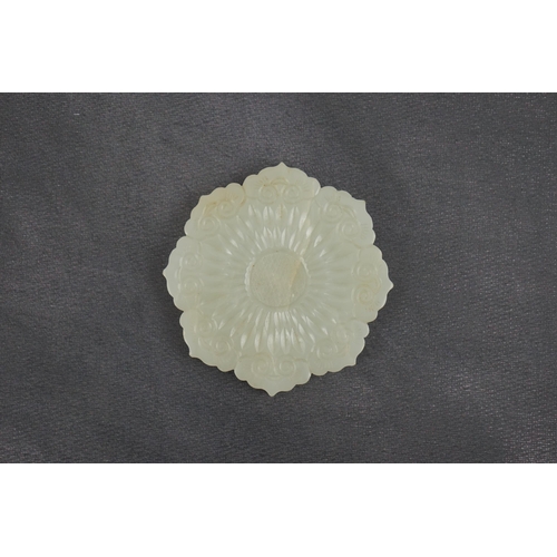 256 - A Chinese pale celadon jade mallow flower plaque, 18th/19th century, the tips of the petals carved... 