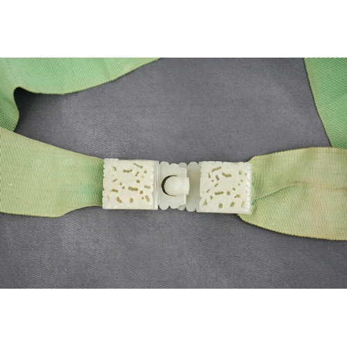 257 - A Chinese pale celadon jade two-piece reticulated belt buckle, 19th century, each section pierced an... 